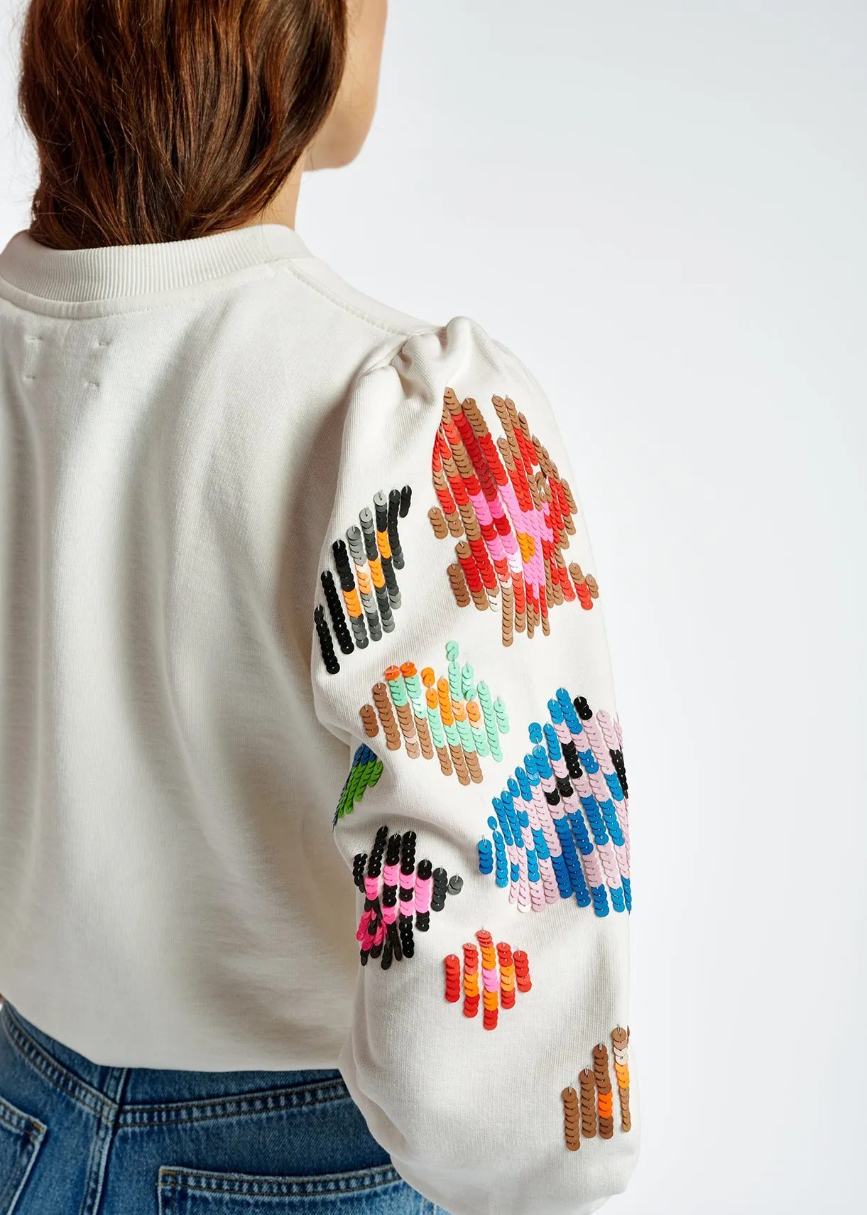 Off-white sweater with multicolor sequin embroideries